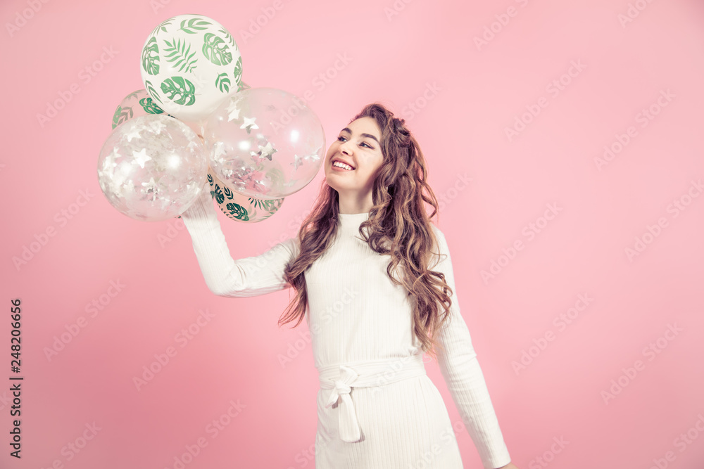 Young girl with balls on a colored background Young girl with balls on a colored background