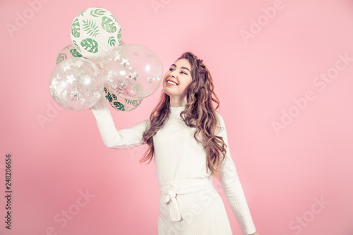 Young girl with balls on a colored background © puhimec