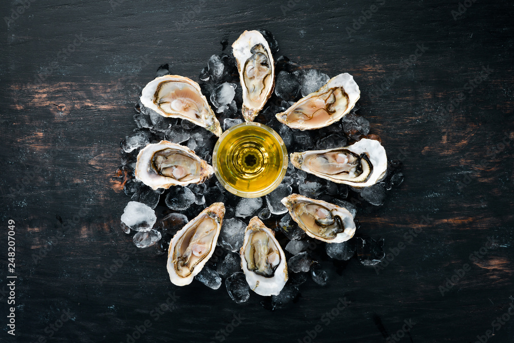 Fresh oysters with ice and white wine. Seafood. Top view. Free copy space. Fresh oysters with ice and white wine. Seafood. Top view. Free copy space.