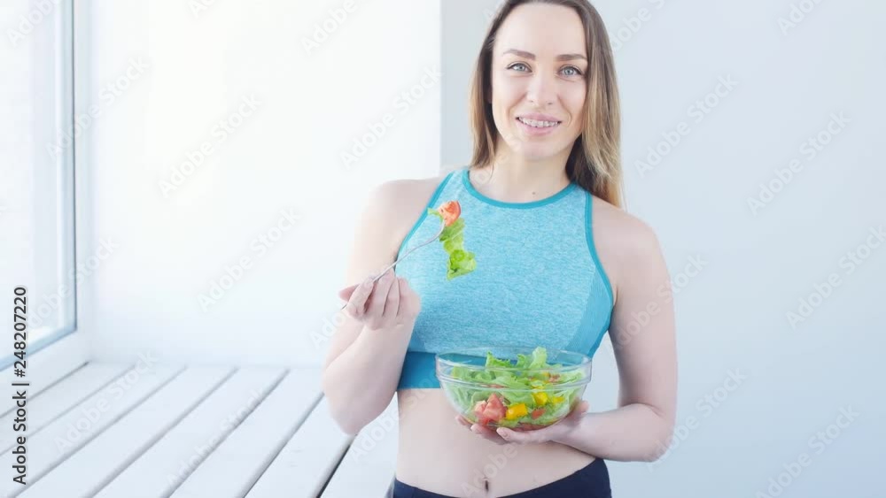 Healthy eating concept. Young Fit woman eating healthy salad after workout Healthy eating concept. Young Fit woman eating healthy salad after workout