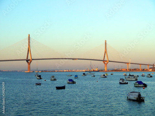 Fishing boats in sunset at the Puente de la Constitución, called La Pepa, in the bay of Cádiz, Andalusia. Spain