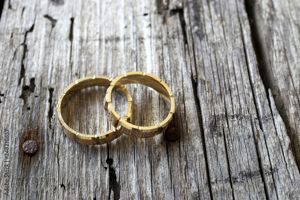 wedding rings on wooden background wedding rings on wooden background