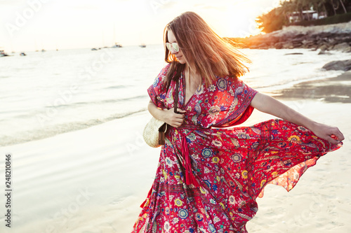 Beautiful girl in boho maxi dress on the beach photo