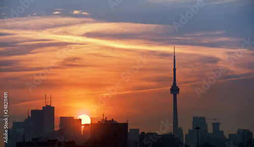 Toronto's skyline lit by sun raising behind the buildings