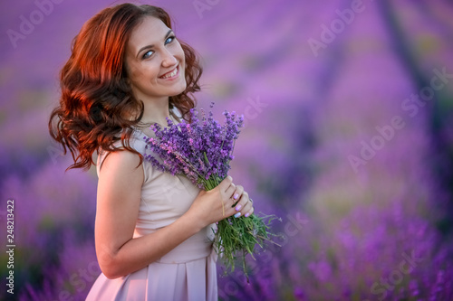 beautiful bride in luxurious wedding dress in purple lavender flowers. Fashion romantic stylish woman with violet bouquet. Alluring slim girl in sunset over lavenda waiting for groom - Provence France