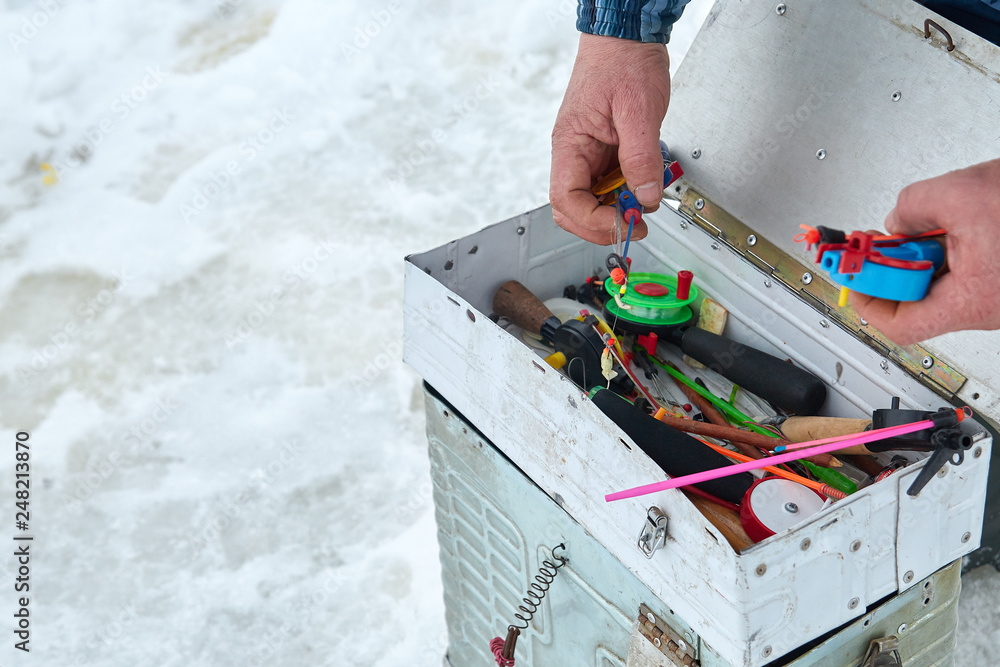 Fishing tackle box on ice. Winter fishing Fishing tackle box on ice. Winter fishing
