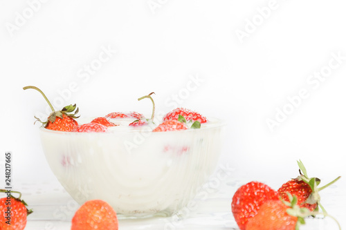 Fresh milk with homemade sweet strawberries on a white background.