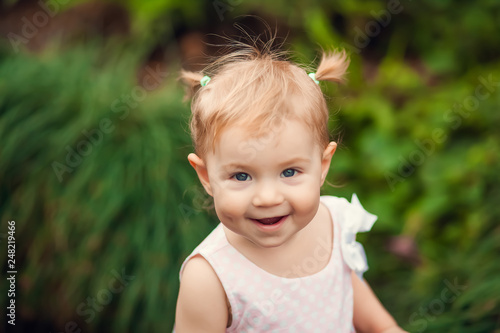 Wallpaper Mural cute little girl smiling in a park close-up Torontodigital.ca