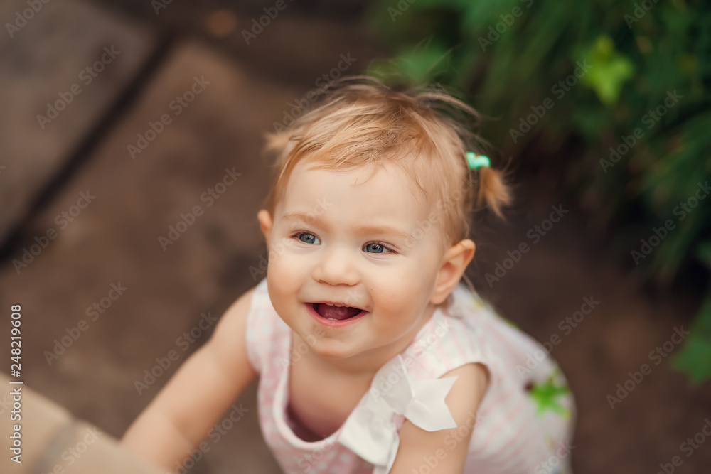 cute little girl smiling in a park close-up