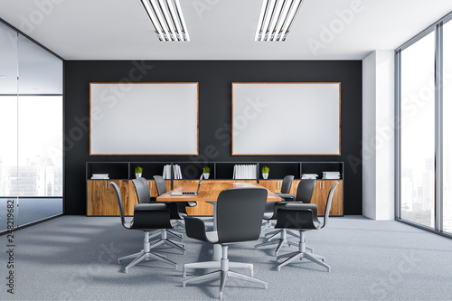 Black meeting room with two posters