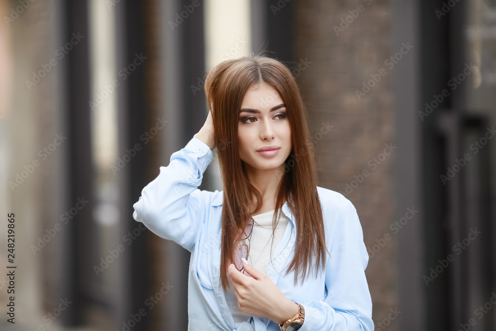 Full Length Portrait of Trendy Hipster Girl Standing at the dark Brick Wall Background. Urban Fashion Concept. Copy Space. Full Length Portrait of Trendy Hipster Girl Standing at the dark Brick Wall Background. Urban Fashion Concept. Copy Space.