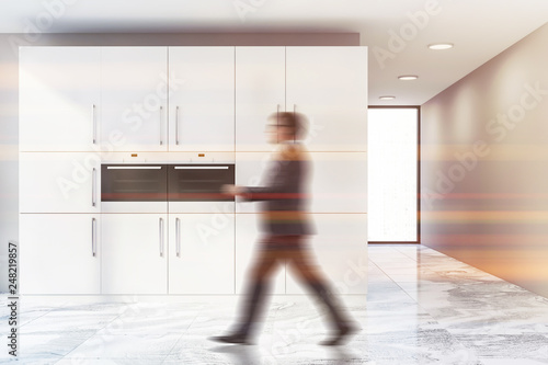 Man in beige kitchen interior with two ovens © ImageFlow