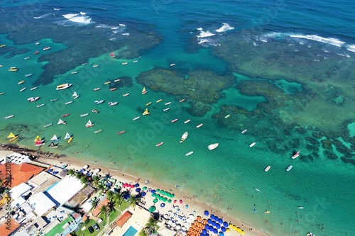 Aerial view of Porto de Galinhas beaches, Pernambuco, Brazil: unique experience of swimming with fishs in natural pools. Beautiful landscape. Candles, sailboats, rafts, boats in the harbor!