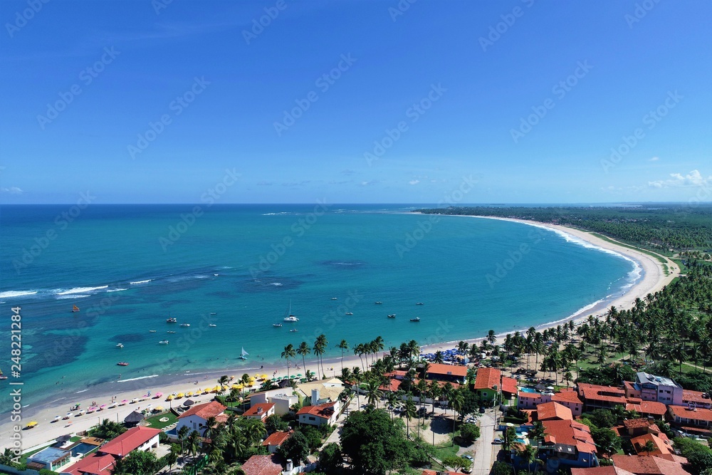 Aerial view of Porto de Galinhas beaches, Pernambuco, Brazil: unique experience of swimming with fishs in natural pools.  Beautiful landscape. Candles, sailboats, rafts, boats in the harbor!