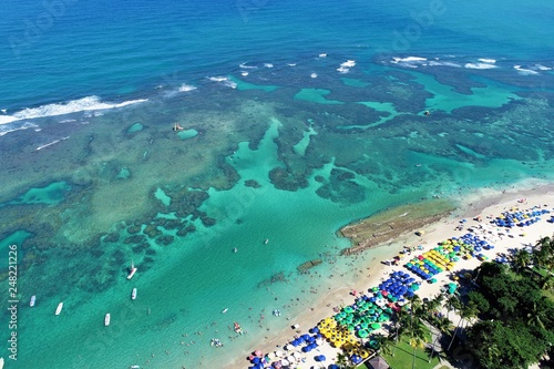 Aerial view of Porto de Galinhas beaches, Pernambuco, Brazil: unique experience of swimming with fishs in natural pools. Beautiful landscape. Candles, sailboats, rafts, boats in the harbor!