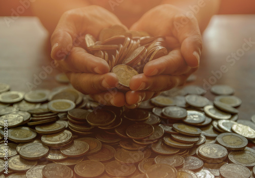Many coin on hands for save  Saving money.