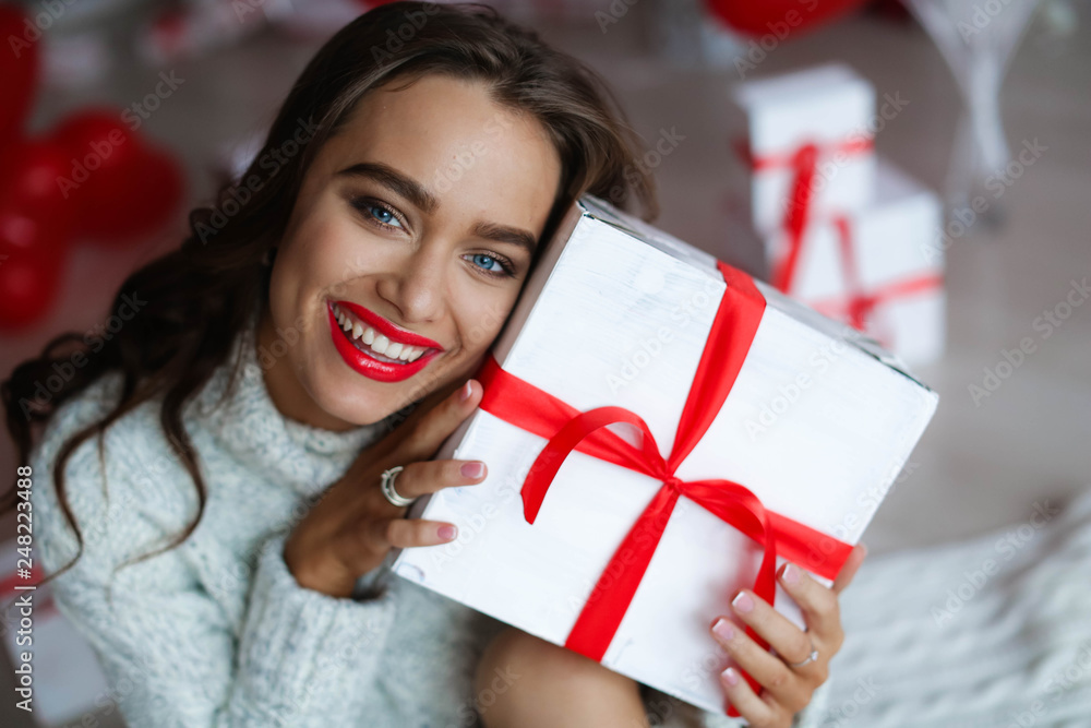 Attractive beautiful and sexy woman with perfect smile and teeth. With makeup at birthday or valentines day holding gift and balloons Attractive beautiful and sexy woman with perfect smile and teeth. With makeup at birthday or valentines day holding gift and balloons