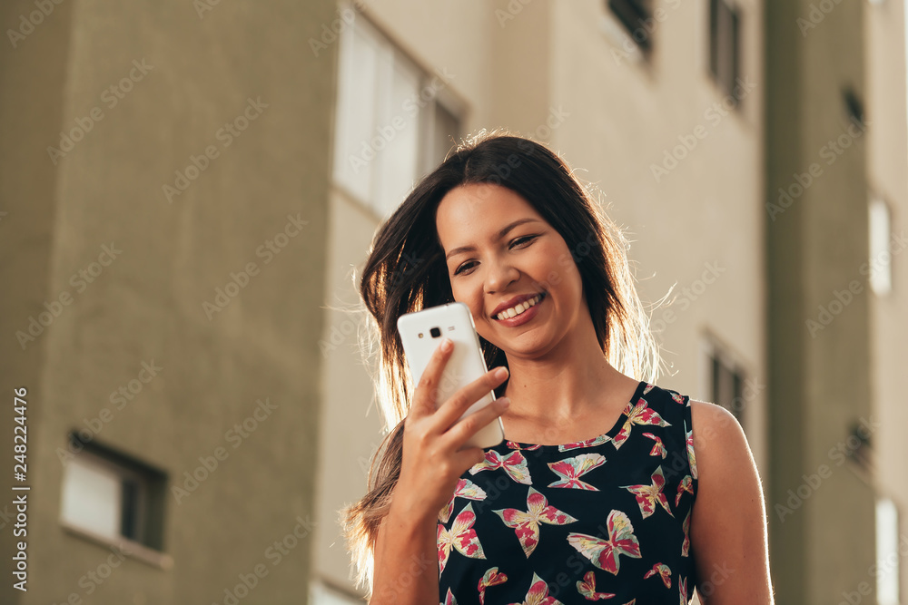 Happy beautiful woman using smart phone outdoors Happy beautiful woman using smart phone outdoors