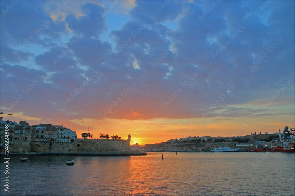 Sunset over the quiet bay of Malta.