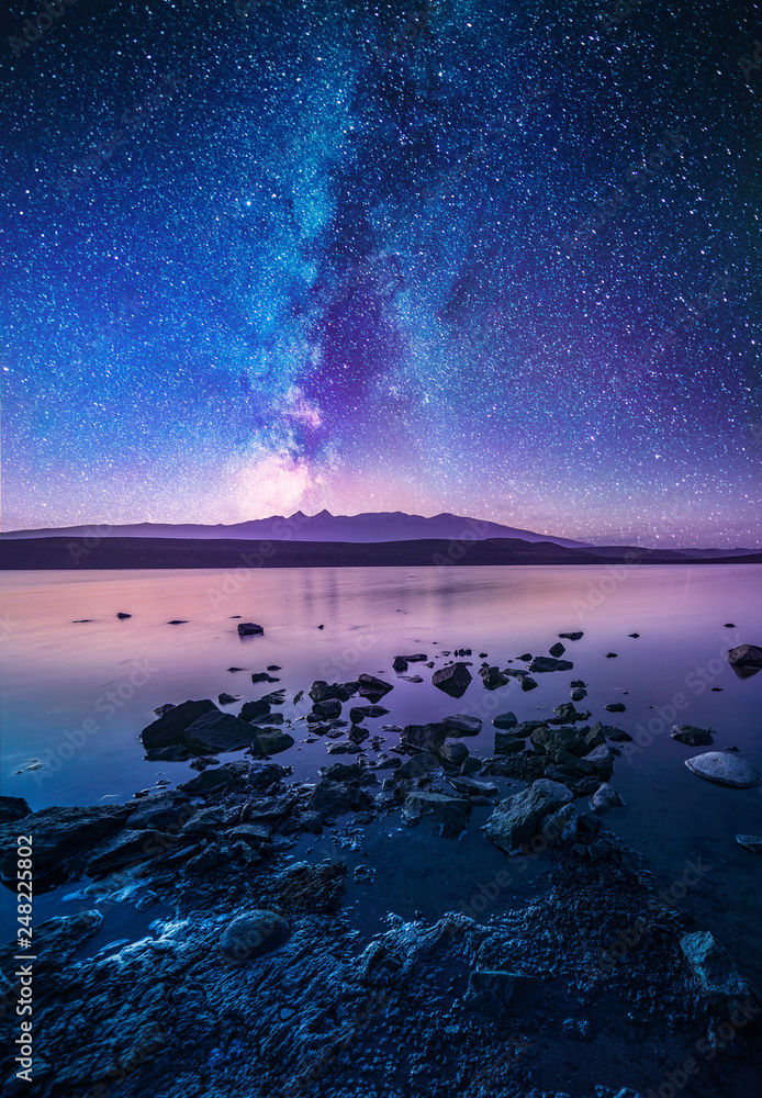 Colorful milky way galaxy over the lake and mountain. Beautiful night landscape. - obrazy, fototapety, plakaty 