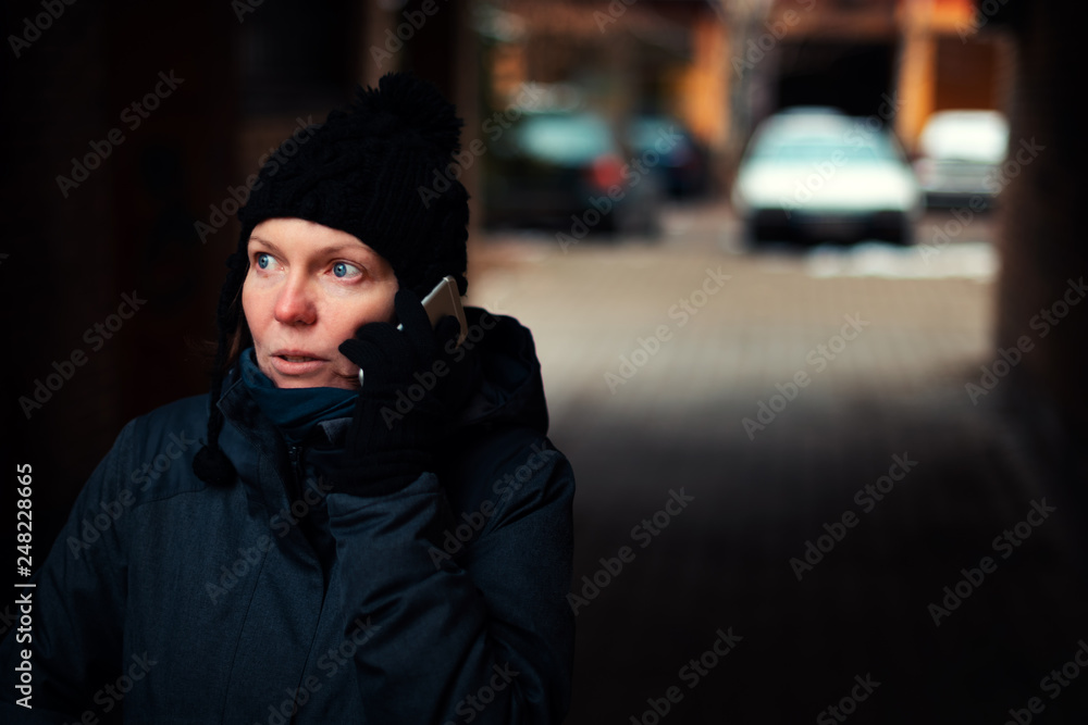 Concerned worried woman talking on mobile phone Concerned worried woman talking on mobile phone