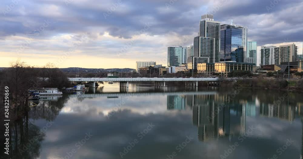 Austin Texas city skyline over river bridge sunset fast motion. Brilliant sunset colors. Lady Bird Lake, Town Lake is a river reservoir on Colorado River in Austin, Texas. Congress Bridge crosses. Austin Texas city skyline over river bridge sunset fast motion. Brilliant sunset colors. Lady Bird Lake, Town Lake is a river reservoir on Colorado River in Austin, Texas. Congress Bridge crosses.