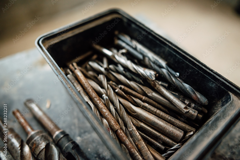 set of steel milling cutters for milling cutters in a rectangular box on the old black table, building old drills, work tools set of steel milling cutters for milling cutters in a rectangular box on the old black table, building old drills, work tools