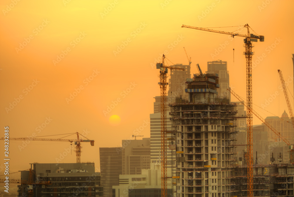 Construction zone with cranes building skyscrapers