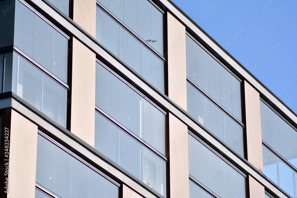 Modern apartment buildings on a sunny day with a blue sky. Facade of a modern apartment building Modern apartment buildings on a sunny day with a blue sky. Facade of a modern apartment building
