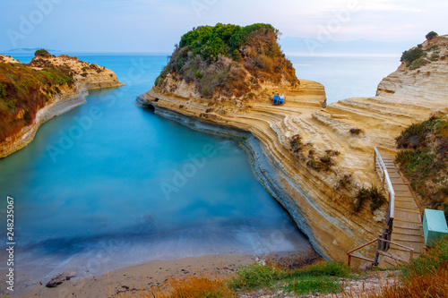 Famous Canal d'Amour beach with beautiful rocky coastline in amazing blue Ionian Sea at sunrise in Sidari holiday village on Corfu island photo