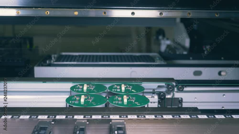 Green circuits are being produced by an industrial equipment Green circuits are being produced by an industrial equipment