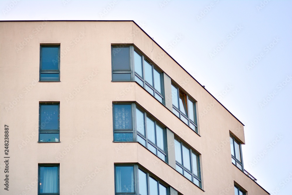 Modern apartment buildings on a sunny day with a blue sky. Facade of a modern apartment building Modern apartment buildings on a sunny day with a blue sky. Facade of a modern apartment building
