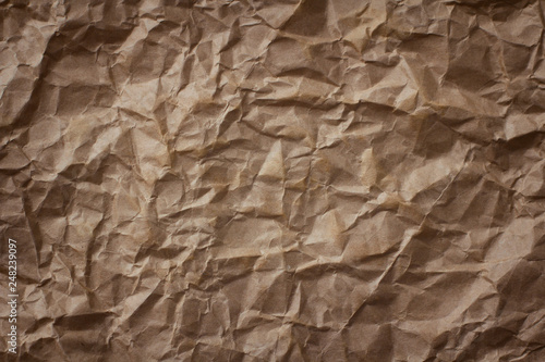 Crumpled brown craft paper texture background.