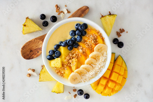 Tapeta Healthy pineapple, mango smoothie bowl with coconut, bananas, blueberries and granola