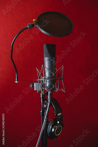 Microphone for recording music in the studio. Red background.