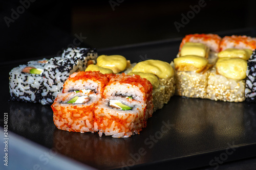 closeup of rolling up sushi on the kitchen with knife and Ingredients