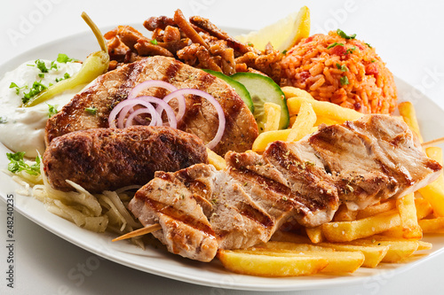 Assorted grilled meat with chips and salad