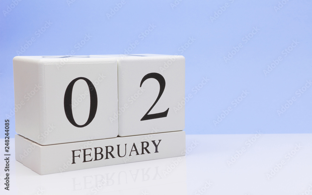 February 02st. Day 02 of month, daily calendar on white table with reflection, with light blue background. Winter time, empty space for text February 02st. Day 02 of month, daily calendar on white table with reflection, with light blue background. Winter time, empty space for text