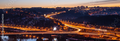 View of Barrandov Bridge over Vltava River in Branik, Prague, Czech Republic. Illuminated roads in cold winter evening © pyty