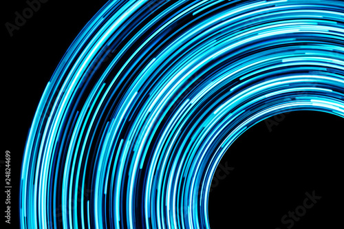 Long exposure abstract blue neon lights background. Black empty copy space.