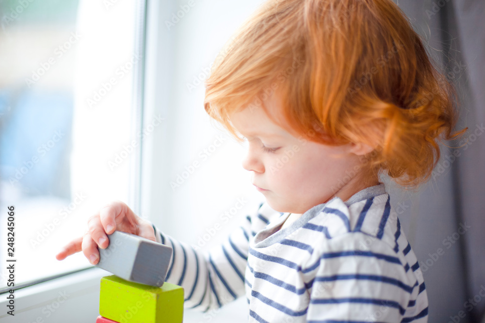 beautiful little girl with red hair by the window,redheaded little girl,pretty baby beautiful little girl with red hair by the window,redheaded little girl,pretty baby