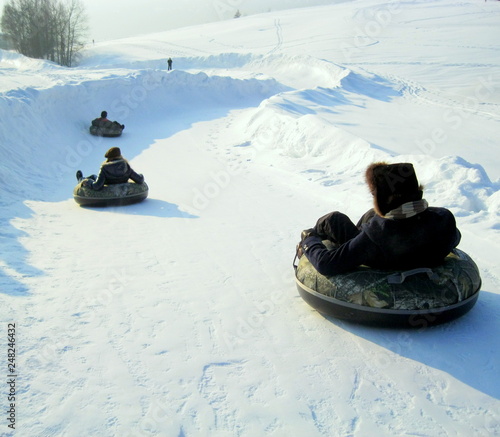 Fun in snow toboganning / Fun sur neige descente en bouées photo