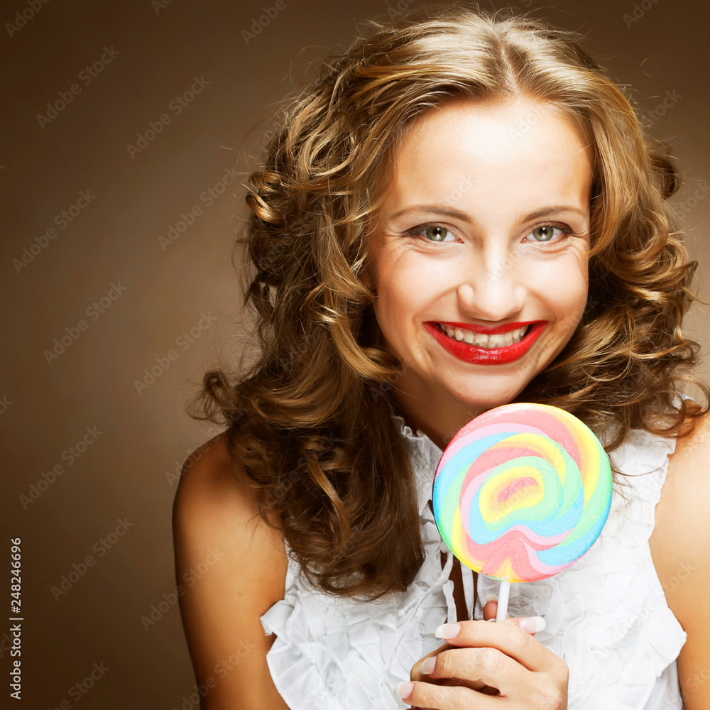 curly  girl with a lollipop in her hand 