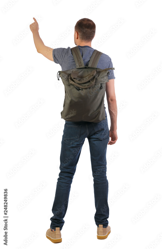 Back view of a man with a green backpack pointing forward. Back view of a man with a green backpack pointing forward.