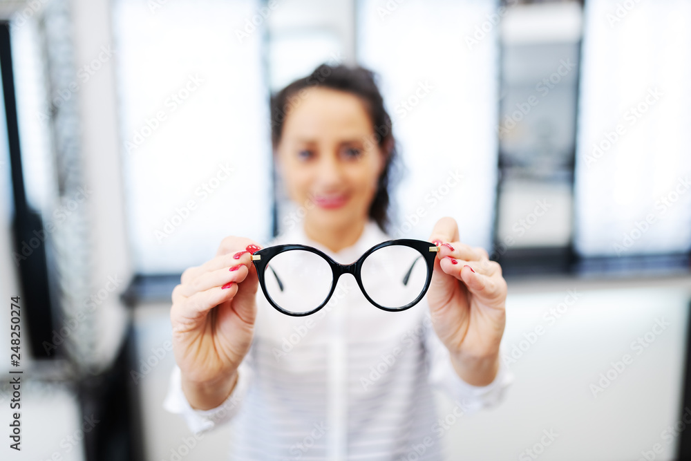 Ταπετσαρία Woman at optician holding eyeglasses she want to buy
