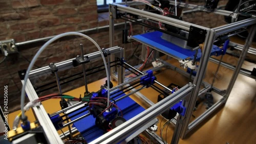 High angle view of two 3D printers in a school makerspace printing student CAD designs photo