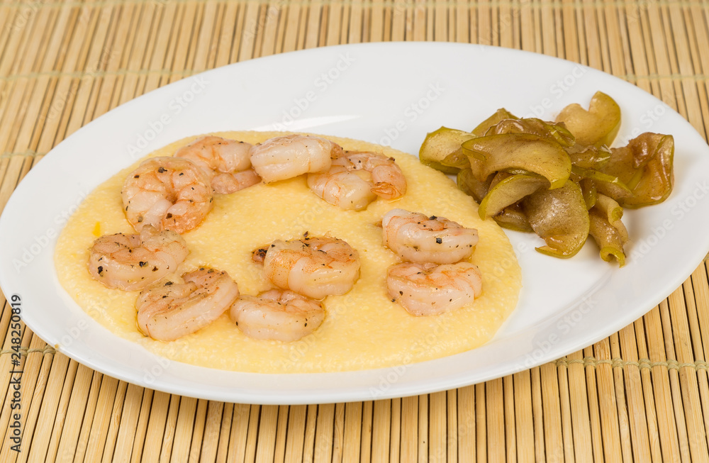 Sauteed Shrimp on Cheese Grits with Candied Apples on Bamboo Mat Sauteed Shrimp on Cheese Grits with Candied Apples on Bamboo Mat