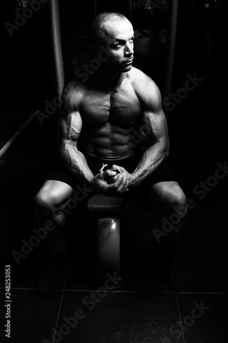 Attractive Young Man Resting In Gym Afther Exercise