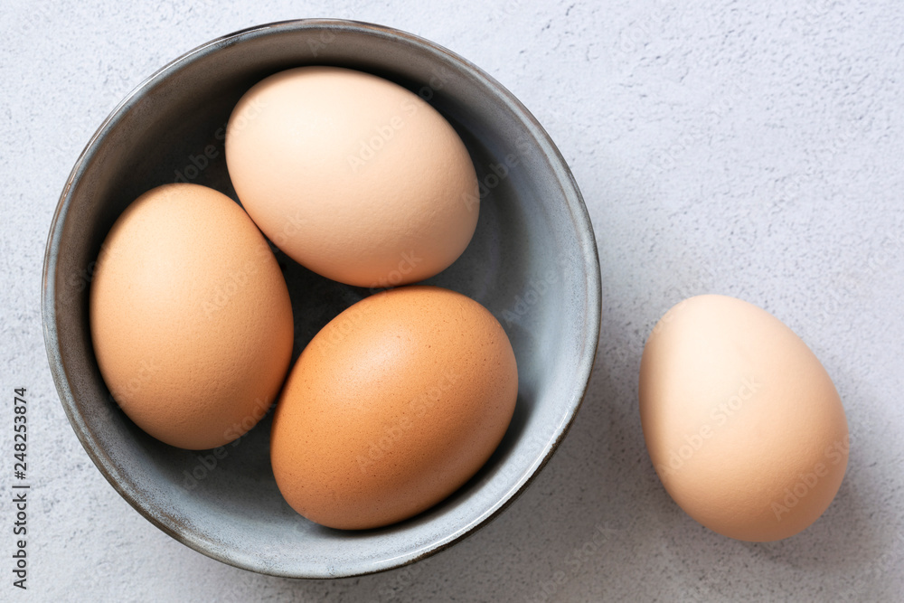 Brown free-range hen eggs in a bowl. Brown free-range hen eggs in a bowl.