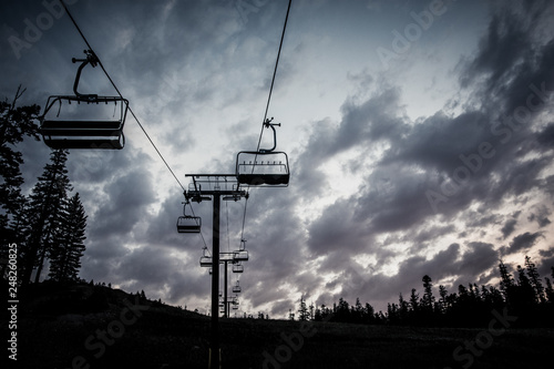 Chair lift at a ski resort in the mountains in the summer at sunset